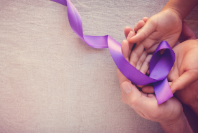 Image of hands and purple ribbon